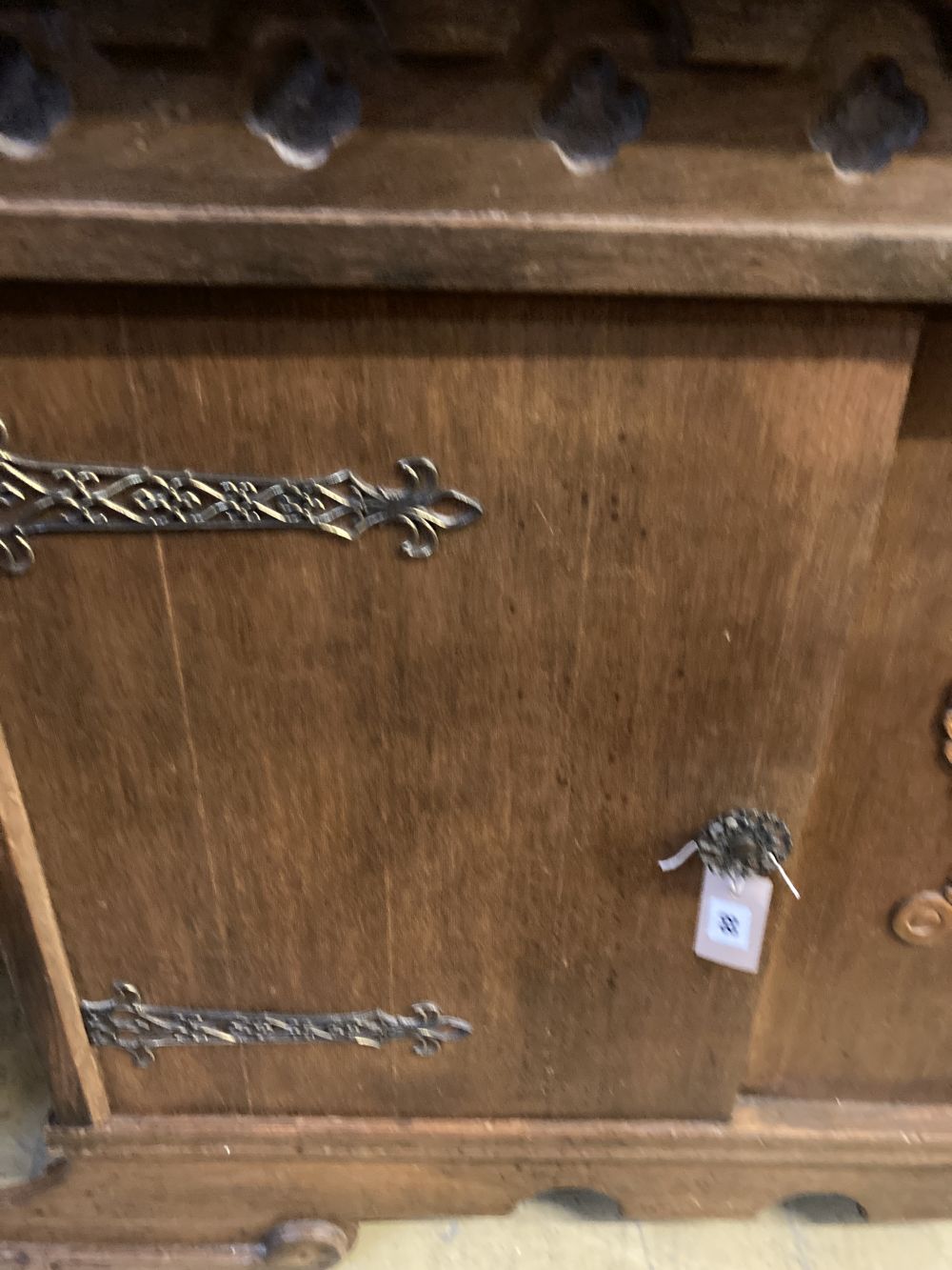 A 1930s oak Gothic inspired sideboard, width 180cm depth 50cm height 116cm